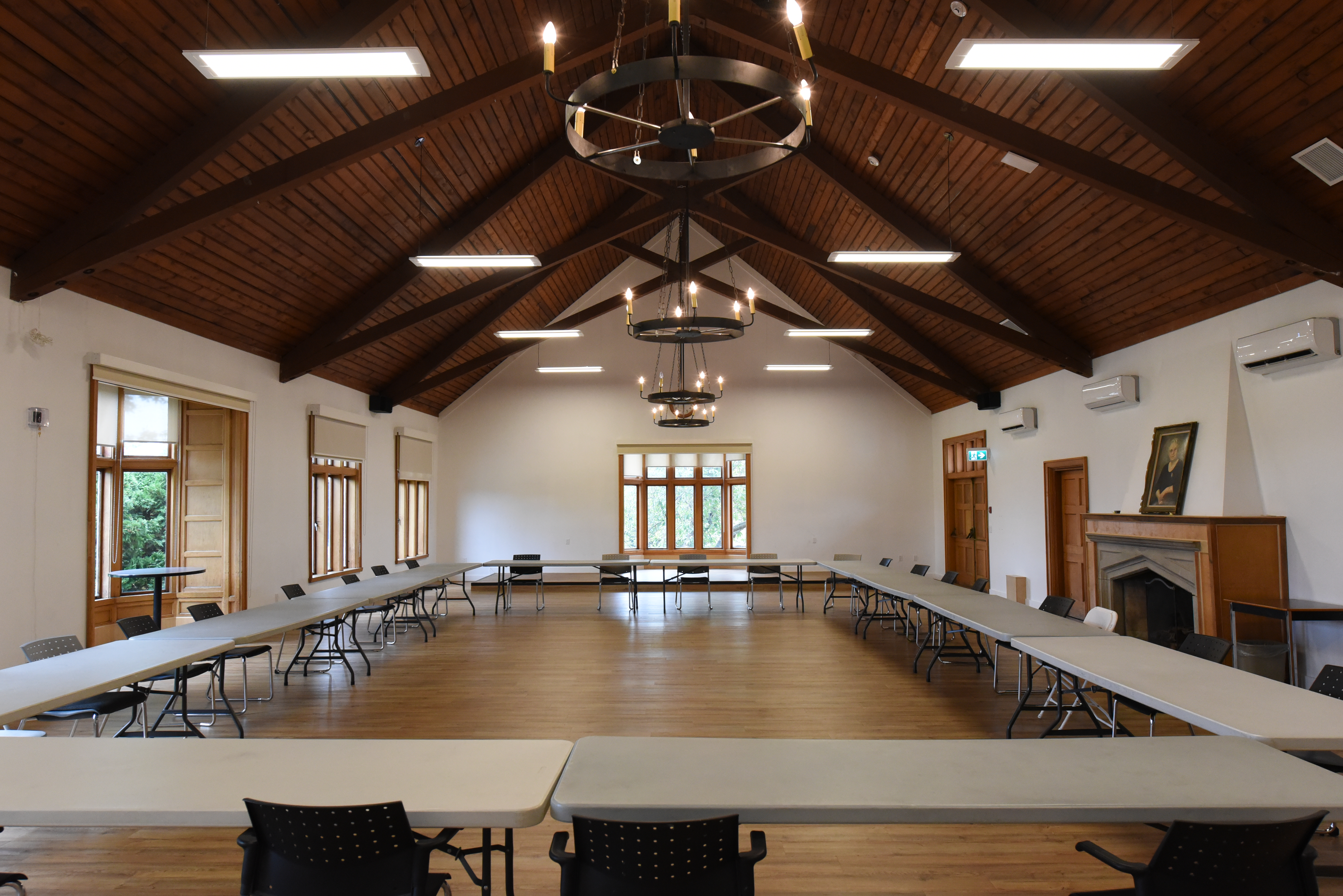 Indoor shot of Brown Hall, with tables and chairs set up for a conference.